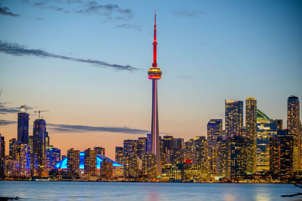 Toronto skyline at dusk with the CN Tower, seen across the water