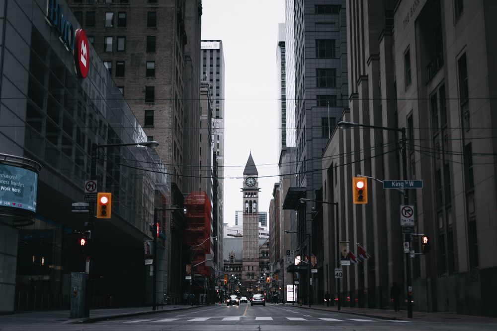 Downtown street between office towers, ending at an old clock tower