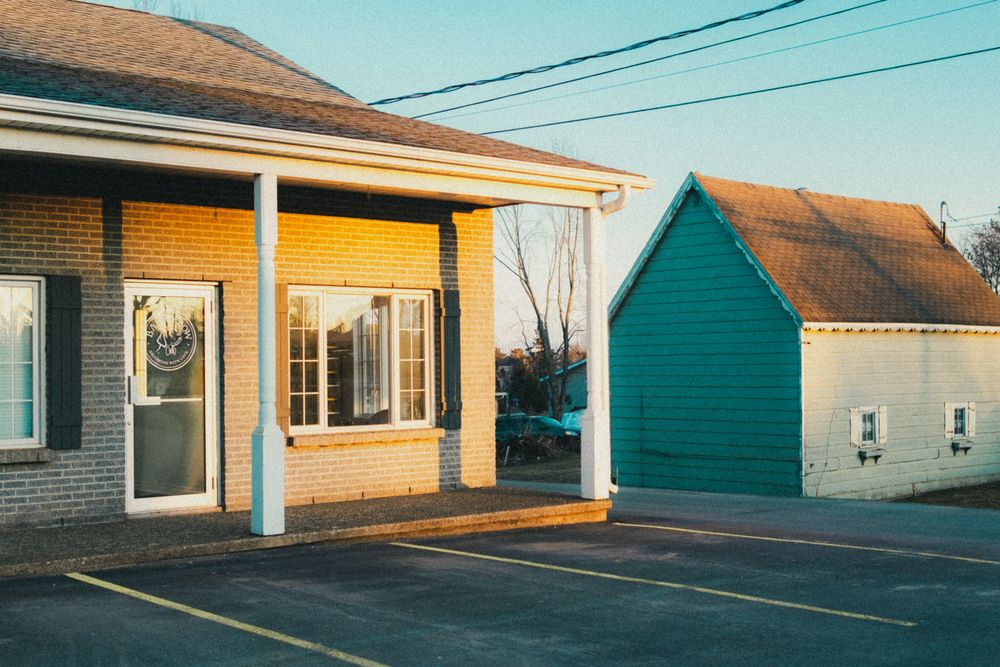 Stock photo: small brick house with a green shed