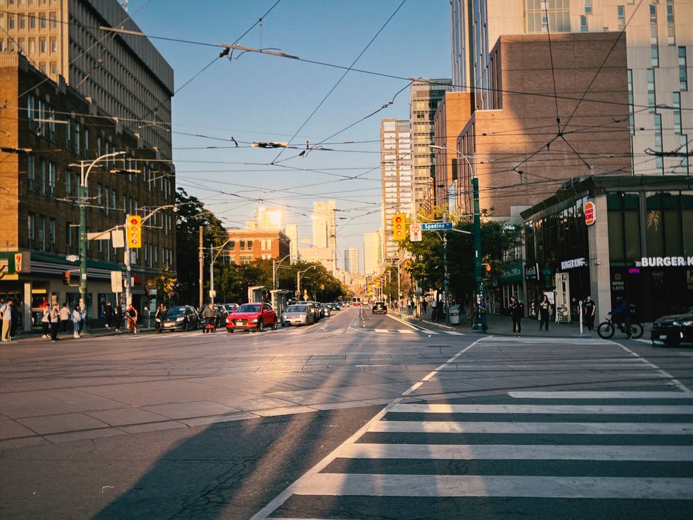 Stock photo: Toronto street corner at Spadina in evening sun, streetcar wires overhead